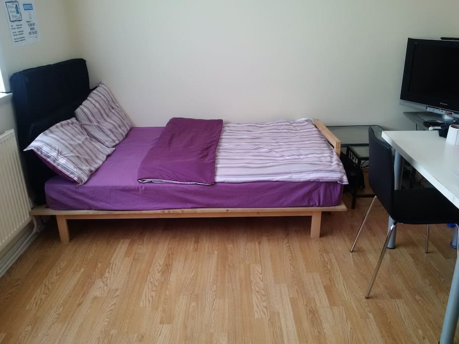 cozy bed in living room - superhost